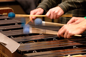 close up of hands playing a xylophone or marimba