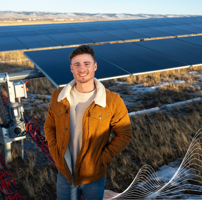 UW student in front of solar panels