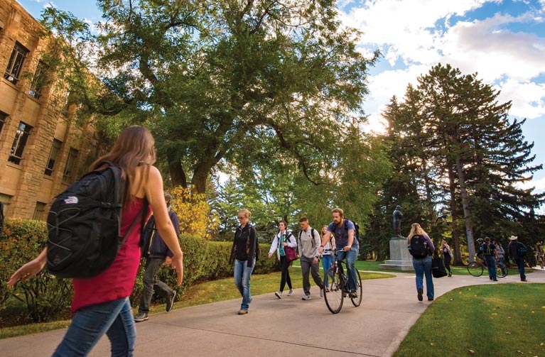 students walking across the UW campus in the summer