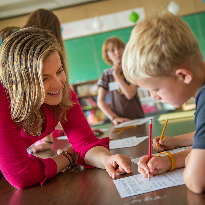 Teacher working with students