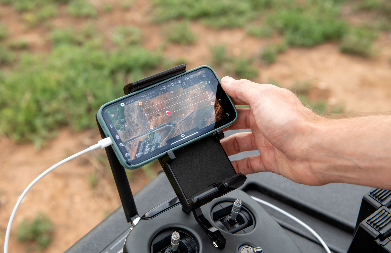 A researcher looks at a map on their phone