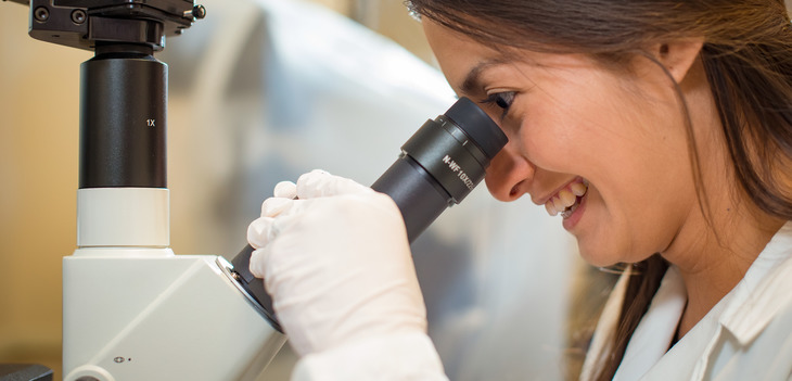 Student looking into microscope