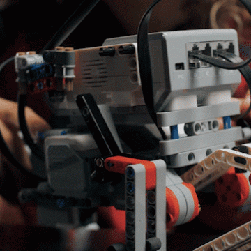 A robot in a technology classroom moves on a table.