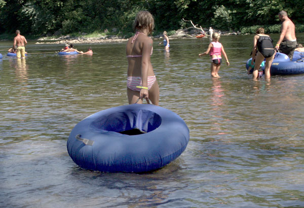 people enjoying water tubing