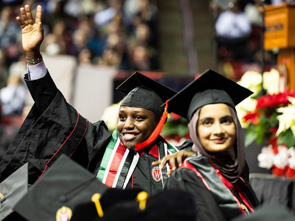 Graduates wave to friends and family members.