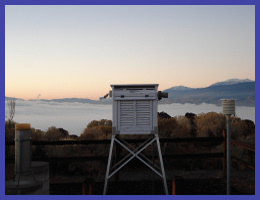 Instrument
            shelter with background valley fog